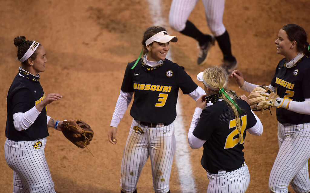 Kimberly Wert, Jenna Laird, Emma Raabe and Kendyll Bailey celebrate between innings